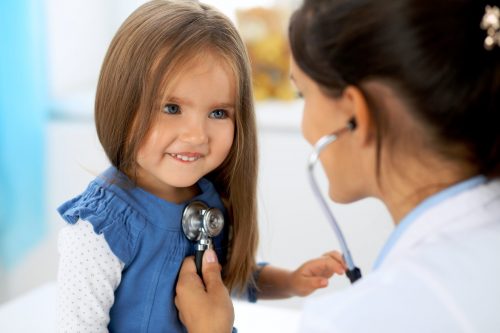 A child being checked up by a nurse